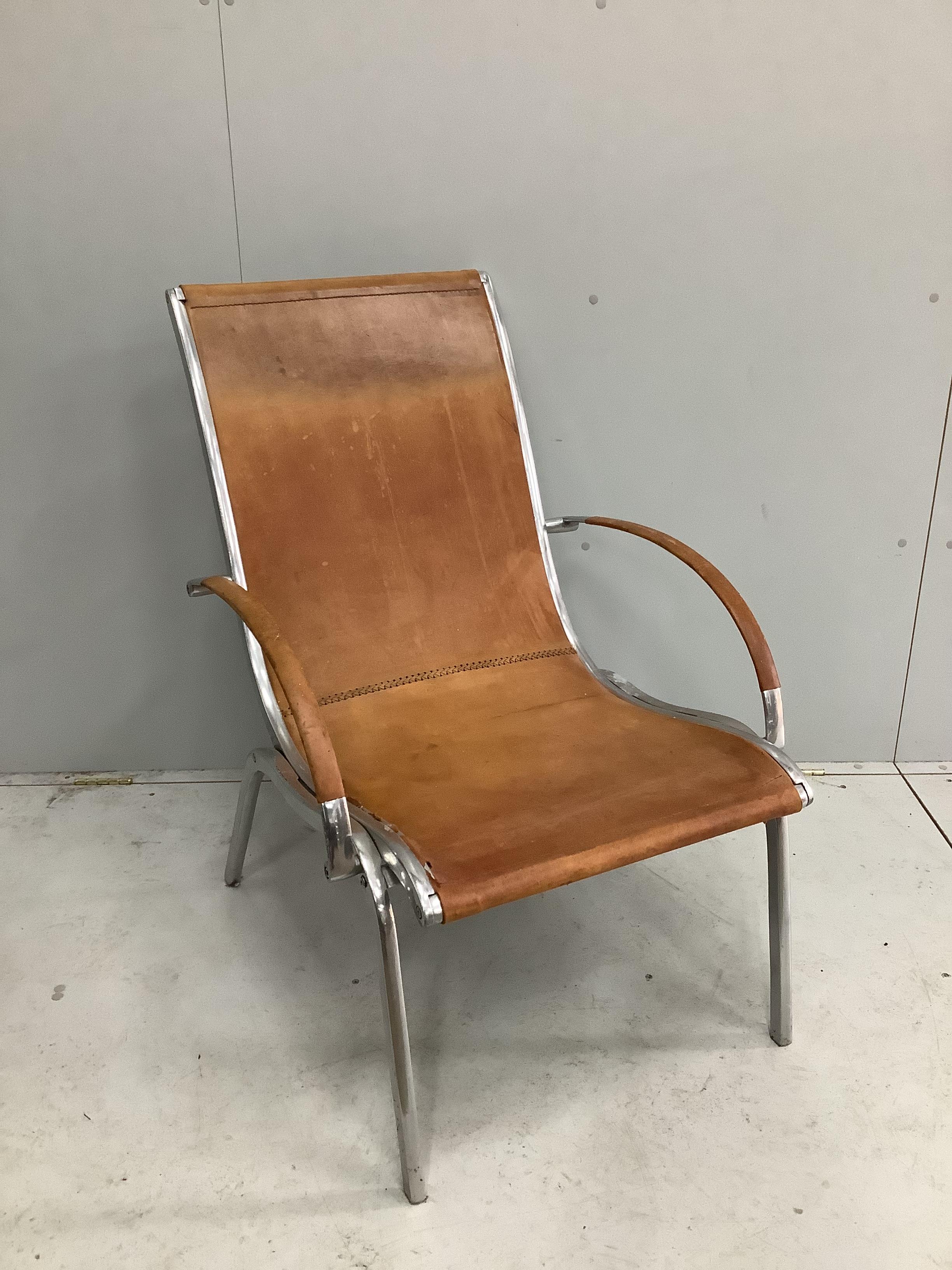An aluminium and tan leather armchair in the manner of Rodolf Szedleczky (seat in need of repair), width 65cm, depth 84cm, height 94cm